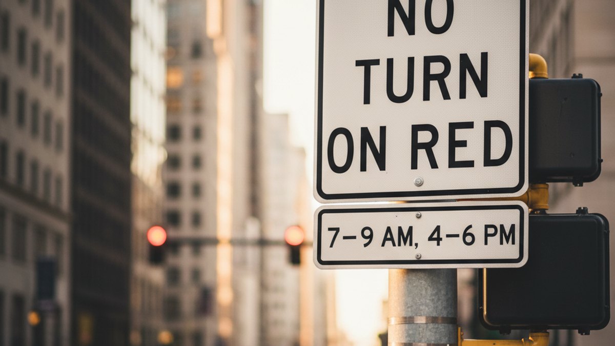 NO TURN ON RED sign with time restriction